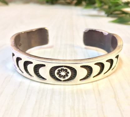 Vintage Hopi silver cuff bracelet with stamped sun, moon and star designs, rare collectible jewelry gift idea.