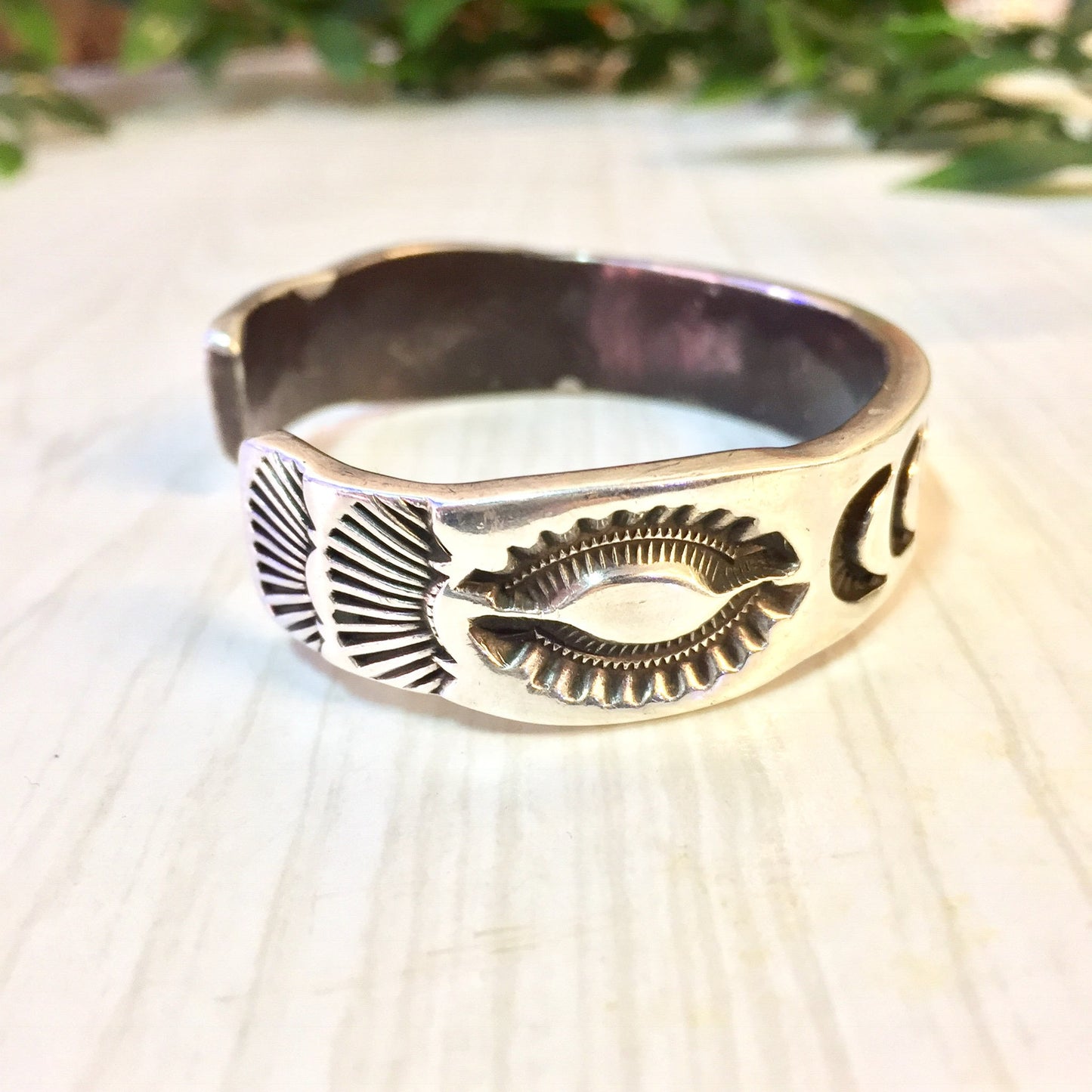 Vintage Hopi silver cuff bracelet with stamped sun, moon, and star designs, a rare piece of Hopi jewelry suitable as a gift.