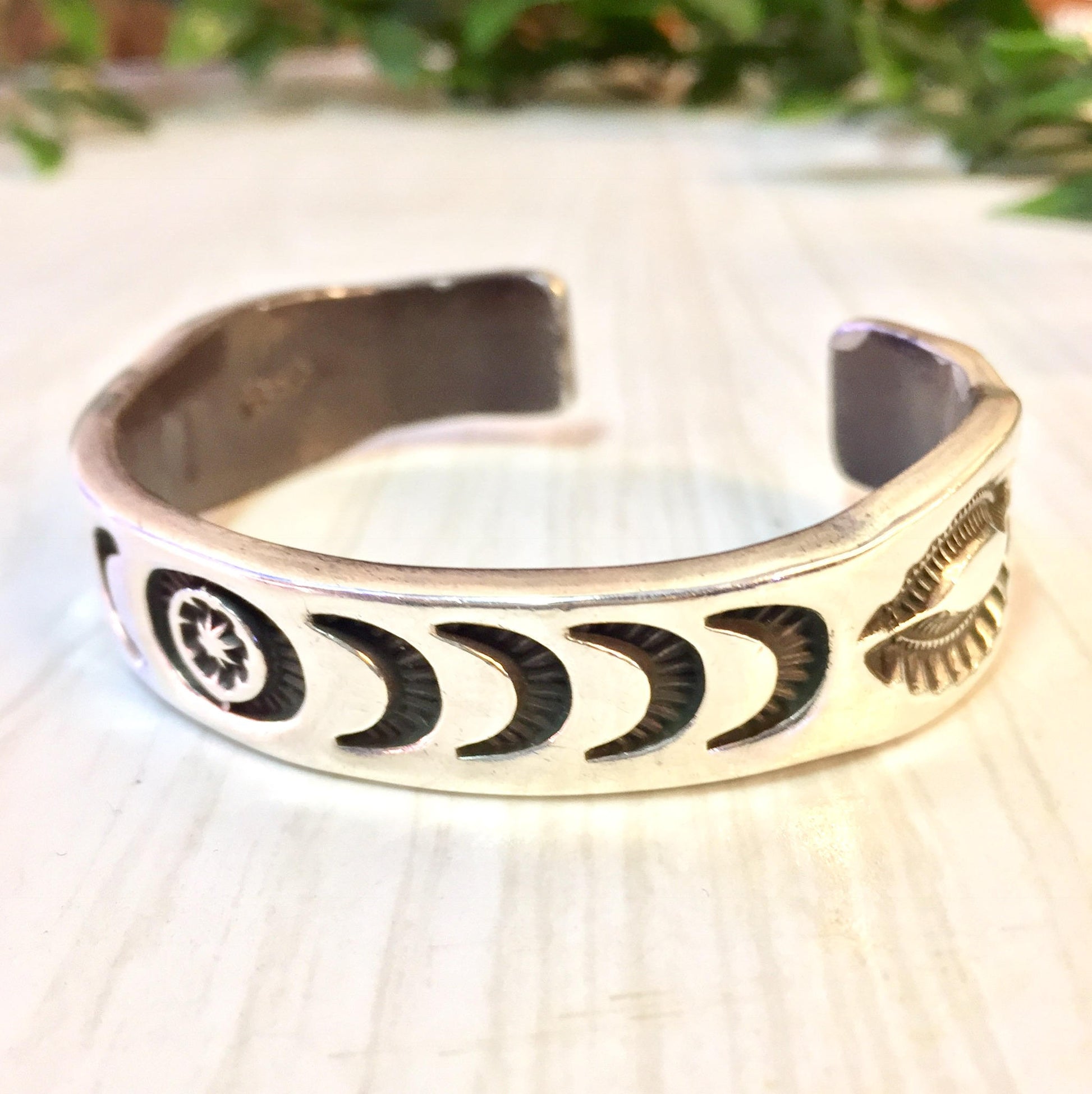 Vintage Hopi silver cuff bracelet with stamped sun, moon and star designs, a rare piece of Hopi jewelry perfect for a unique gift.