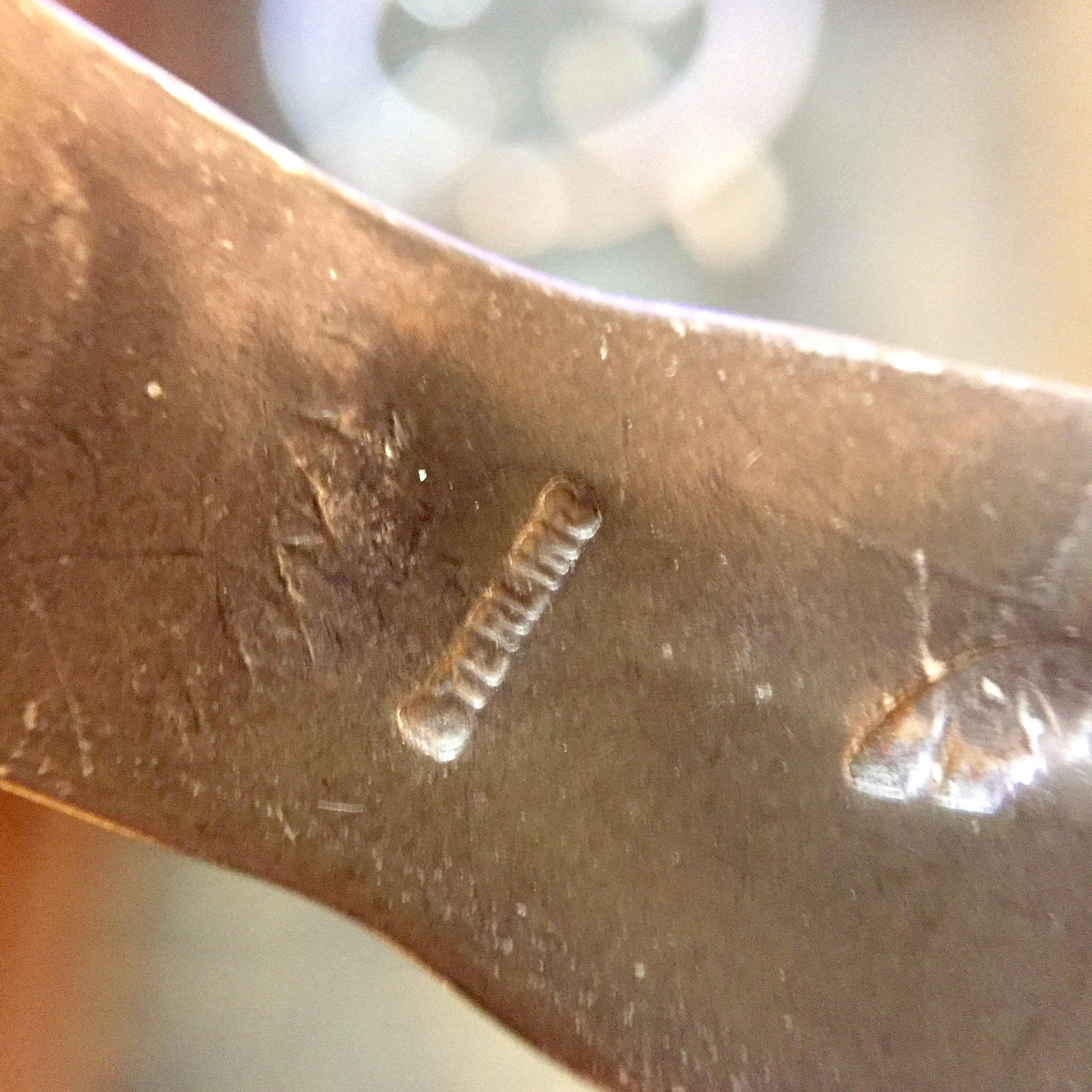 Vintage Hopi silver cuff bracelet with stamped sun, moon and stars design, close-up detail of the engraved metalwork.