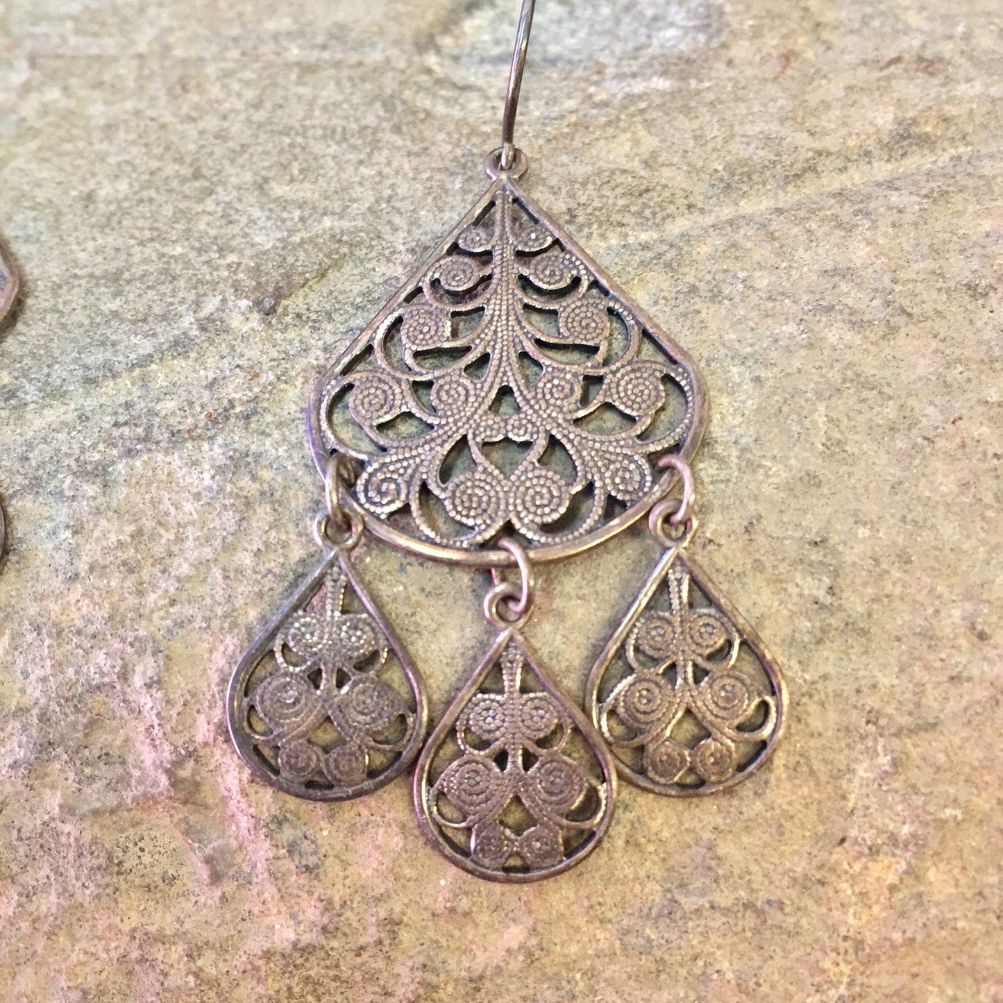 Vintage silver tone chandelier dangle earrings with intricate filigree design, creating an elegant statement jewelry piece from the past.