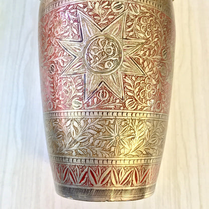 Vintage etched metal cocktail shaker with intricate silver, red and gold floral design