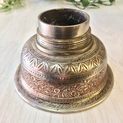 Vintage silver and red etched metal cocktail shaker with intricate floral design, Indian-inspired barware for mixology enthusiasts.