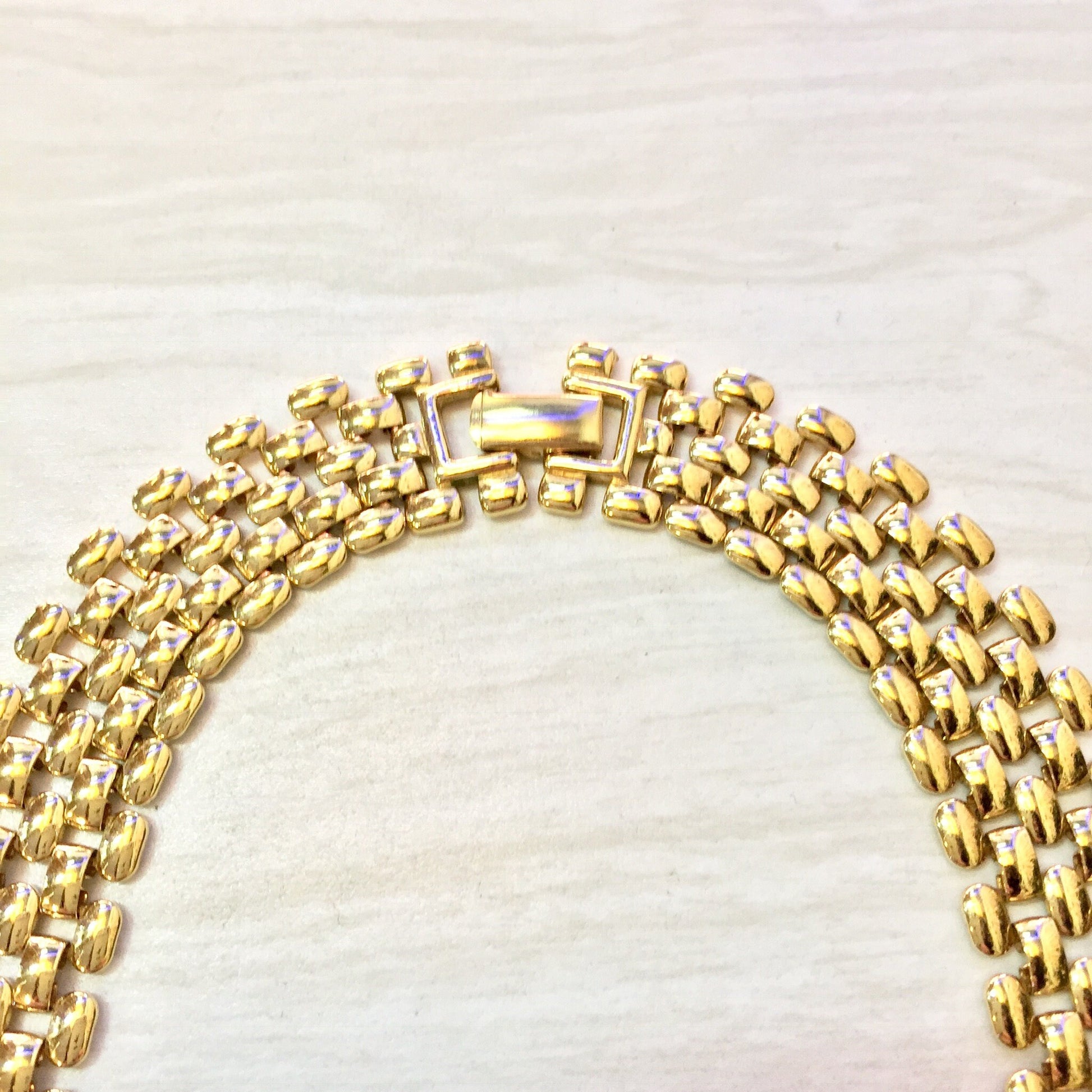 Vintage gold tone chain link statement necklace on light background