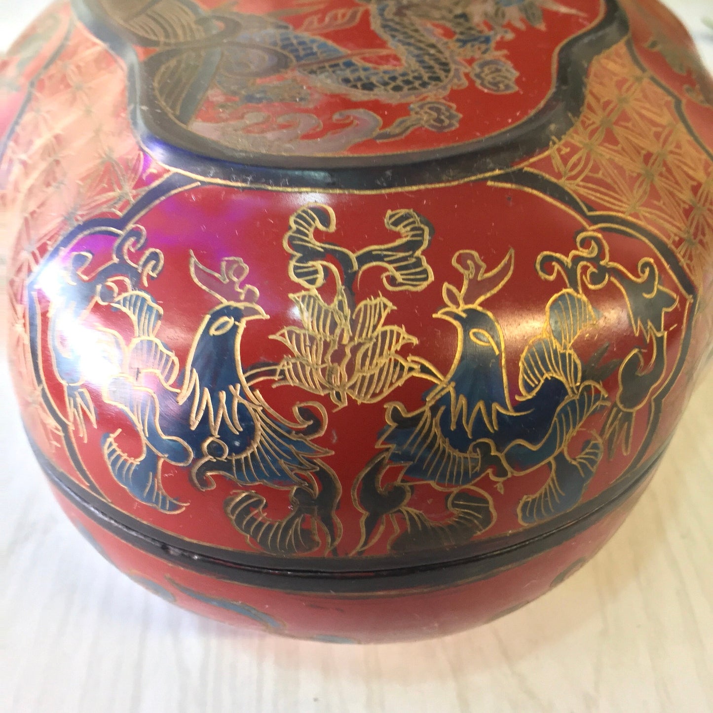 Vintage Asian lacquered box featuring vibrant red color with intricate gold and blue dragon designs, suitable for storing jewelry, trinkets or serving as a decorative catch-all dish.