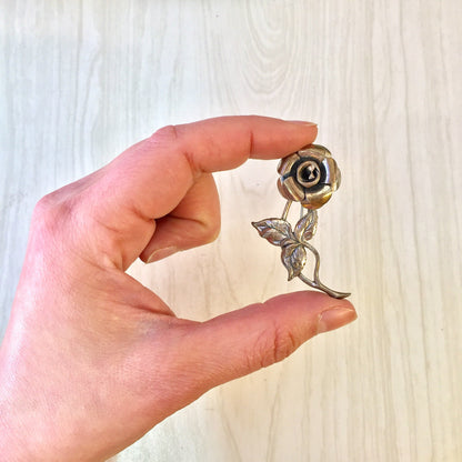 Vintage sterling silver rose brooch pin held in hand, featuring intricate detailing and design, perfect as a thoughtful gift for Mother's Day or any occasion.