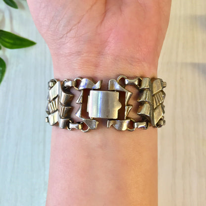 Vintage silver tone link bracelet on wrist, costume jewelry statement piece, metal bracelet gift idea