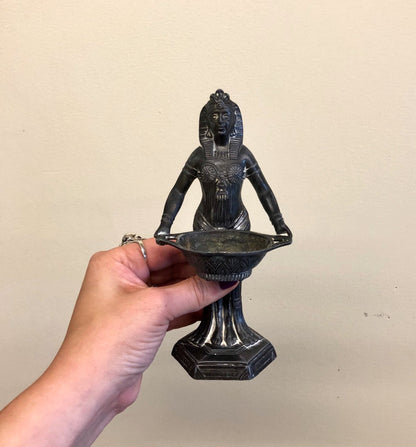 Vintage Art Deco Egyptian revival incense burner sculpture held in hand, depicting a goddess figurine. Black cast metal incense holder in Egyptian style from Vantines.