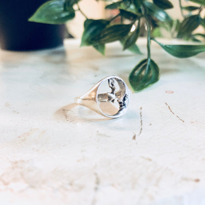 Vintage sterling silver moon and star cutout ring on marble surface with greenery in background, bohemian style promise ring or statement jewelry piece