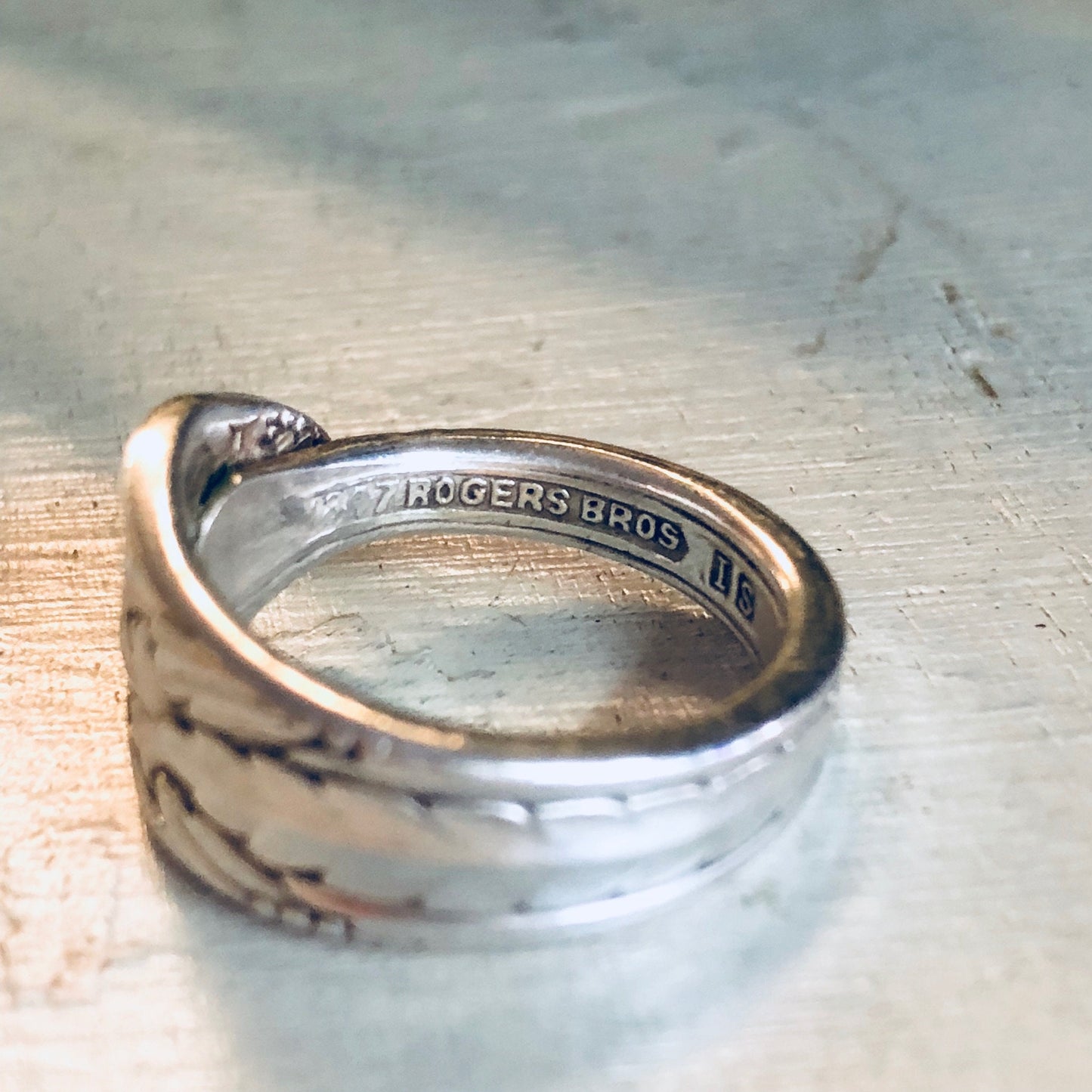 Vintage Rogers Bros silver spoon ring with floral design, repurposed from antique silverware into a unique statement jewelry piece.