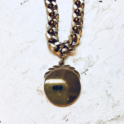 Vintage gold-toned Monet pendant necklace with thick chain and statement jewelry design