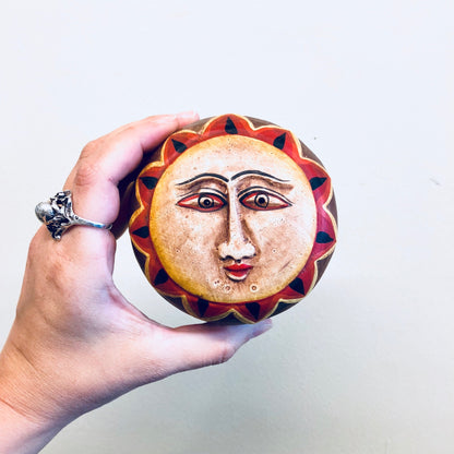 Wooden sun box featuring a hand-carved sun face design in vibrant red, orange and yellow hues, making a unique vintage lidded container for jewelry or home decor.