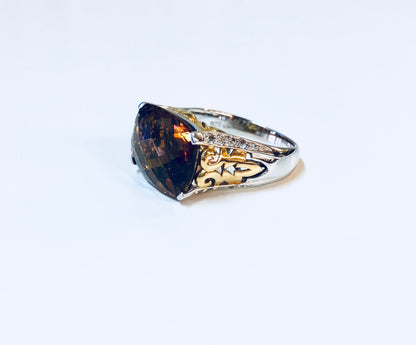 Vintage silver cocktail ring with deep blue topaz stone and intricate gold filigree detailing on the band, a stunning statement jewelry piece for anniversaries or special occasions.