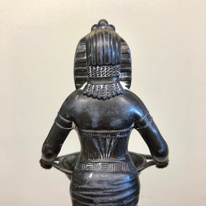Vintage Art Deco Egyptian Revival incense burner sculpture depicting goddess figurine, made of dark patinated metal with intricate carved details on the headdress and garment.