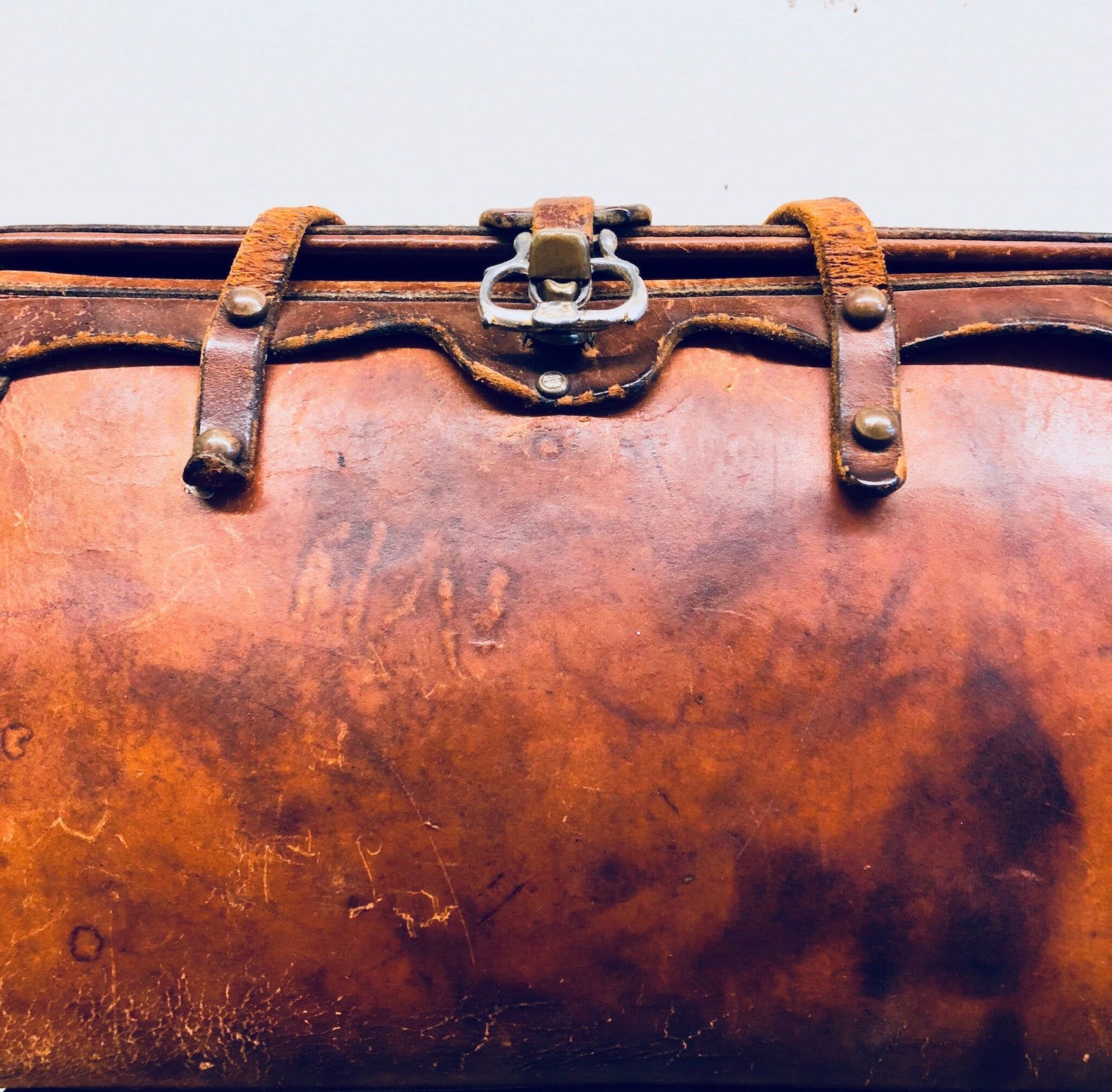 Vintage brown leather handbag with leather strap and metal closure, well-worn patina, rustic bohemian style purse from the 1960s era