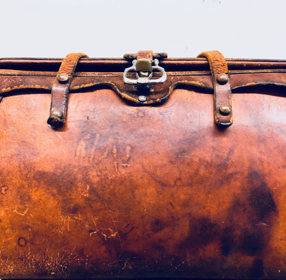 Vintage brown leather handbag with leather strap and metal closure, well-worn patina, rustic bohemian style purse from the 1960s era