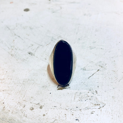 Vintage sterling silver ring with large oval black onyx cabochon stone, creating a bold cocktail ring statement piece