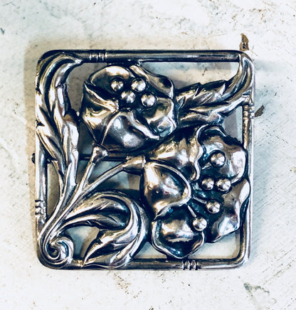 Vintage Dancraft sterling silver floral brooch pin featuring intricate blooming flower design from the 1940s era, crafted in a square shape.