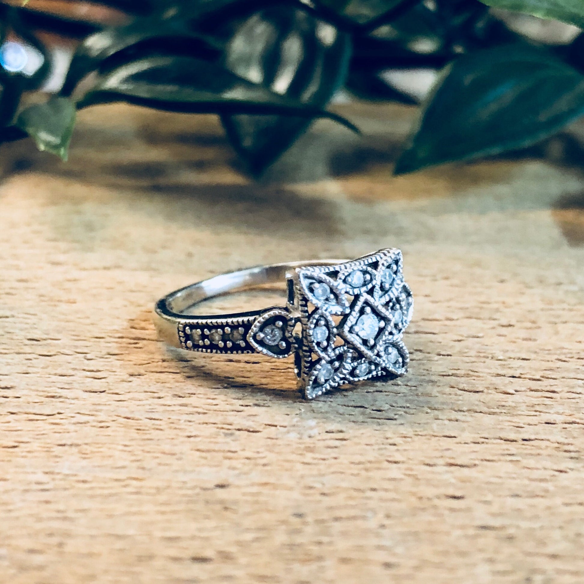 Vintage art deco diamond engagement ring crafted in 14K white gold, featuring intricate geometric design. Timeless bridal jewelry from the early 20th century, perfect for a bride-to-be.