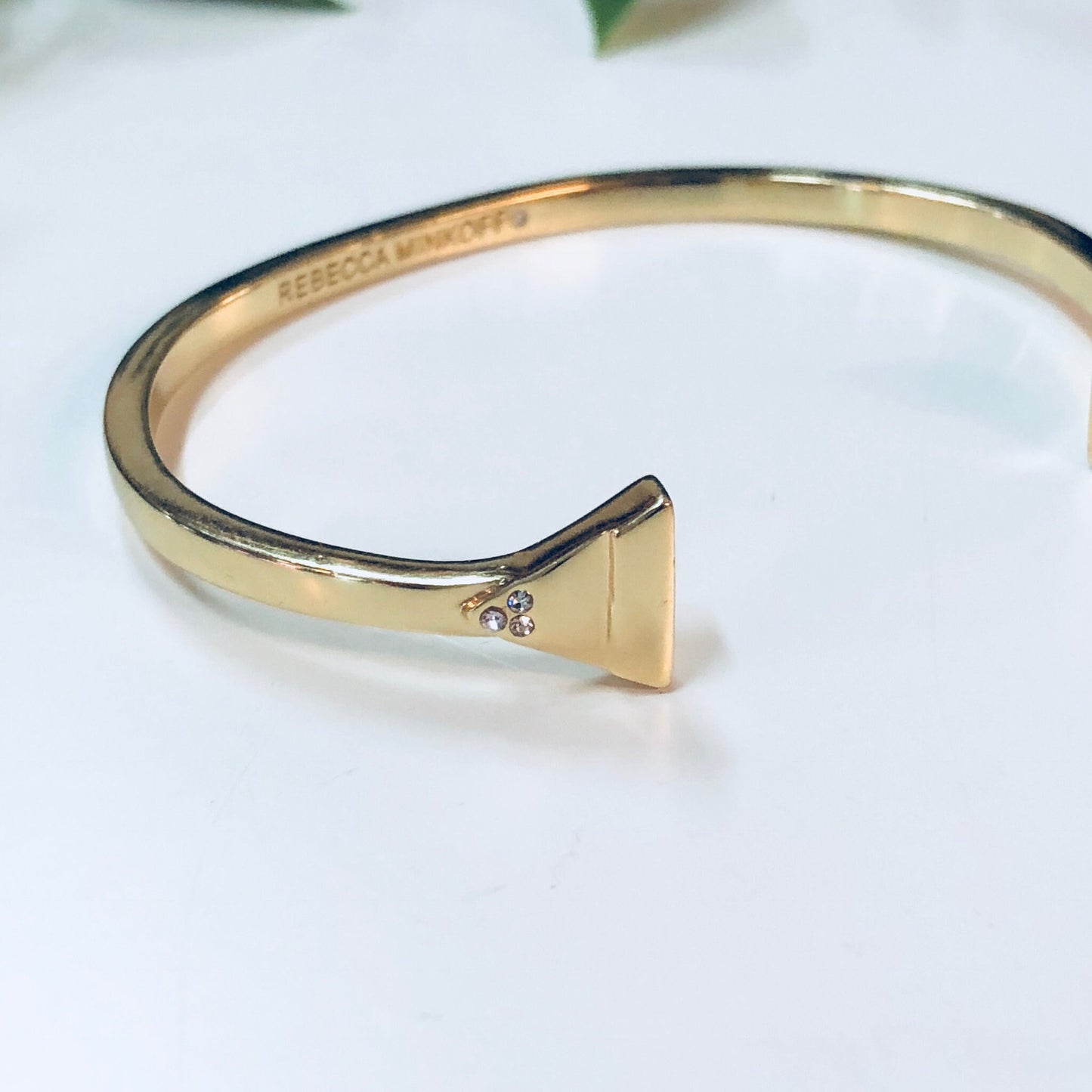 Gold toned cuff bracelet with triangle shape detail by designer Rebecca Minkoff.