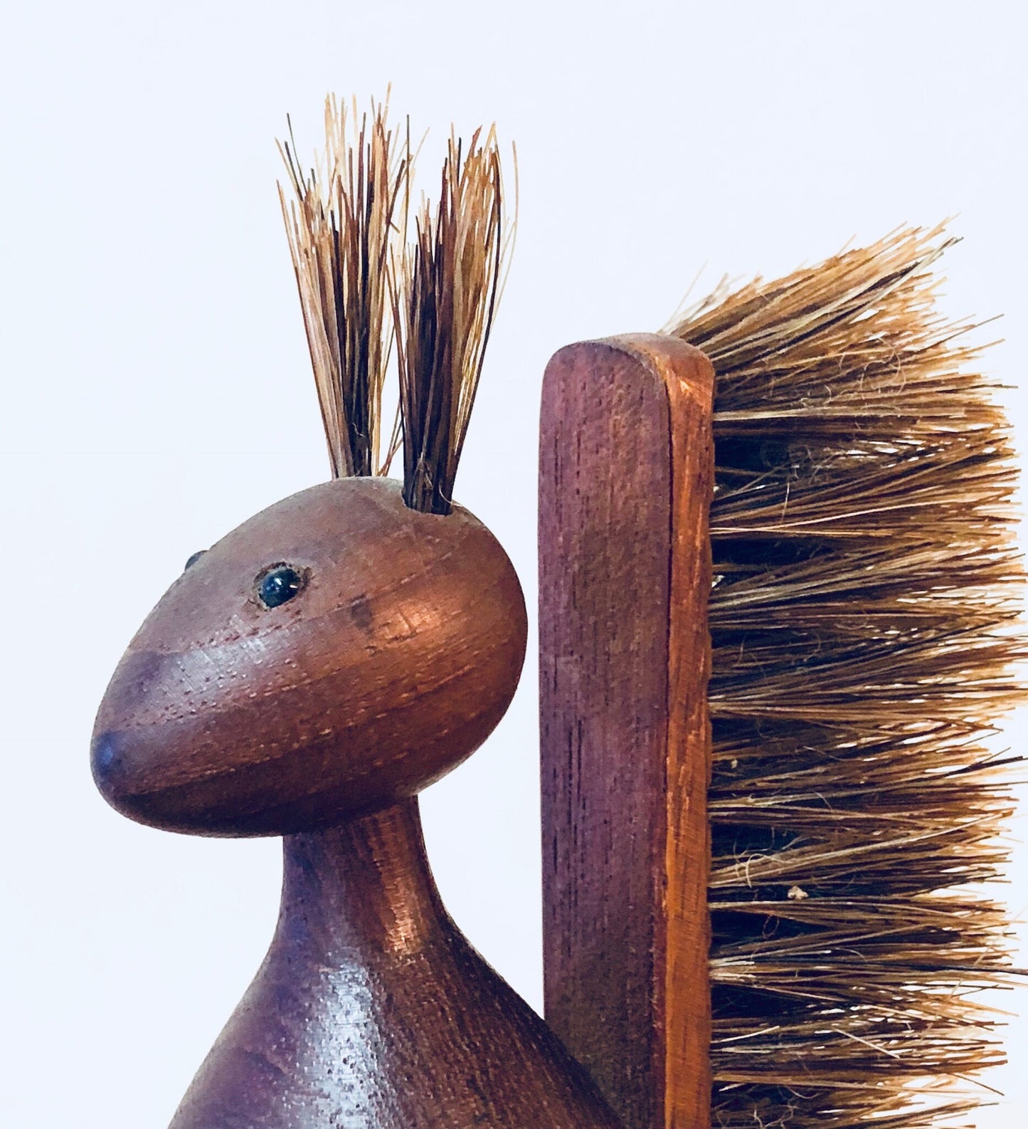 Wooden scrub brush with bristles resembling a cute squirrel, made of carved brown wood, vintage rustic home decor item