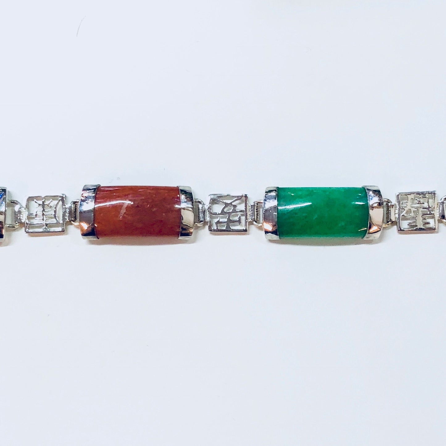 Vintage sterling silver link bracelet with colorful natural stone accents including red, green, and clear stones, Asian-inspired design