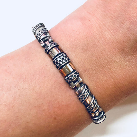 Vintage silver and gold link bracelet with intricate inlay design on wrist, sterling silver 925 stamp, perfect anniversary gift jewelry.