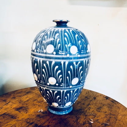 Vintage blue and white ceramic vase with circular pattern, suitable for floral arrangements or as farmhouse-style home decor centerpiece