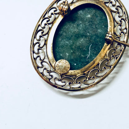 Vintage gold filled brooch with ornate filigree design and round green stone cabochon, antique jewelry pin in 12K gold with deep green and white colors