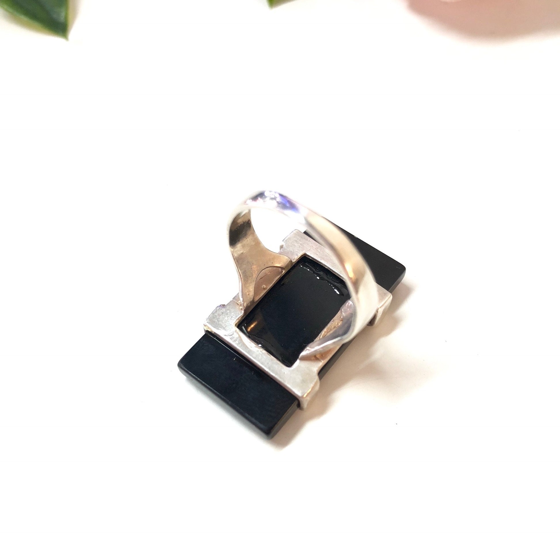 Vintage sterling silver ring with rectangular black onyx stone on white background, minimalist jewelry design