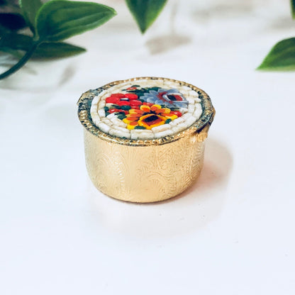 Vintage gold toned millefiori mosaic pill box with colorful red, blue, orange and white swirl paisley design, small trinket case.