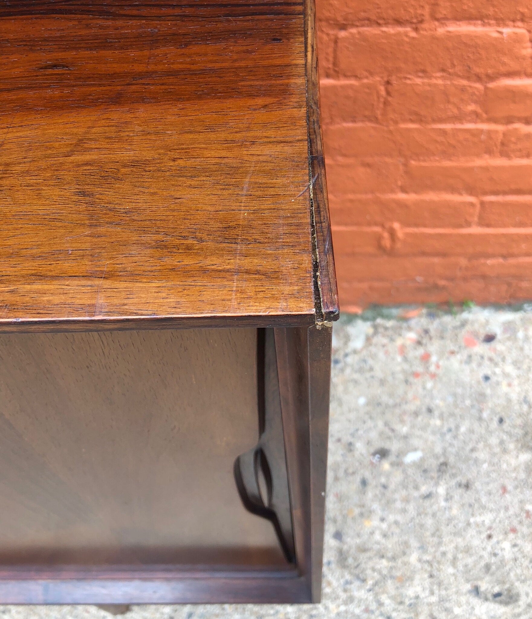 Mid-century modern wood credenza cabinet with teak veneer and intricate joinery, showcasing the iconic style and craftsmanship of MCM furniture design.