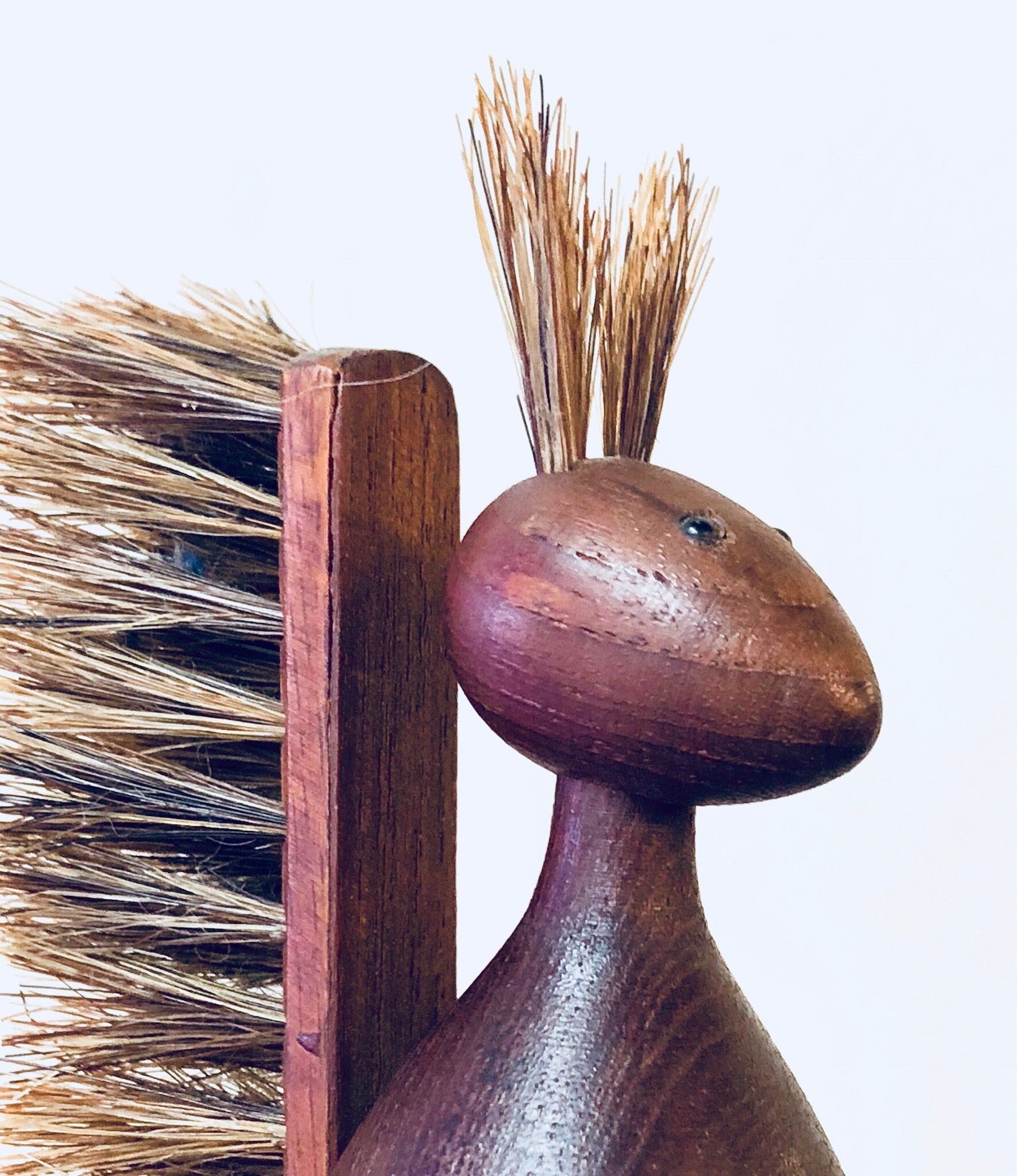Wooden vintage scrub brush shaped like a squirrel with bristles, rustic brown decor