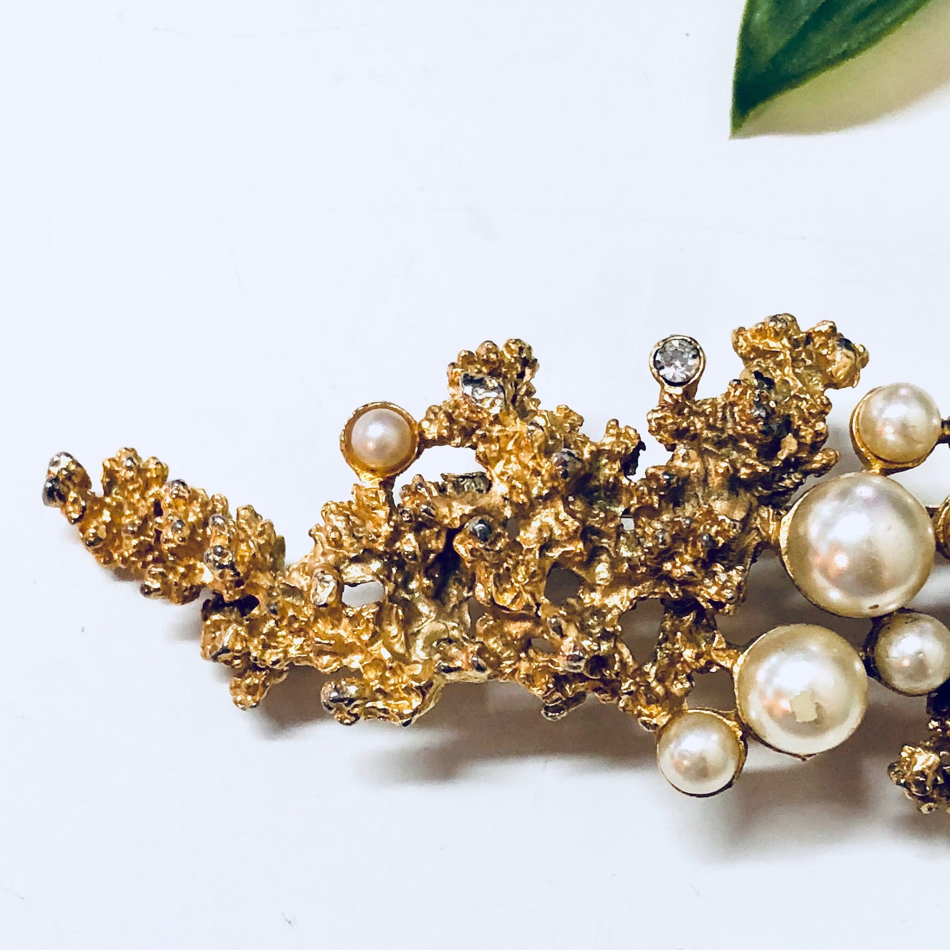 Vintage gold-toned brooch with faux pearls and intricate floral design, statement costume jewelry pin