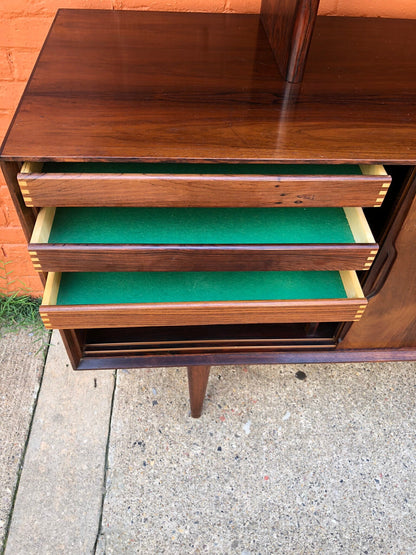 Mid century modern hardwood teak credenza with green felt-lined drawers, perfect for use as a server or buffet. The drawers provide ample storage space in this stylish retro furniture piece.