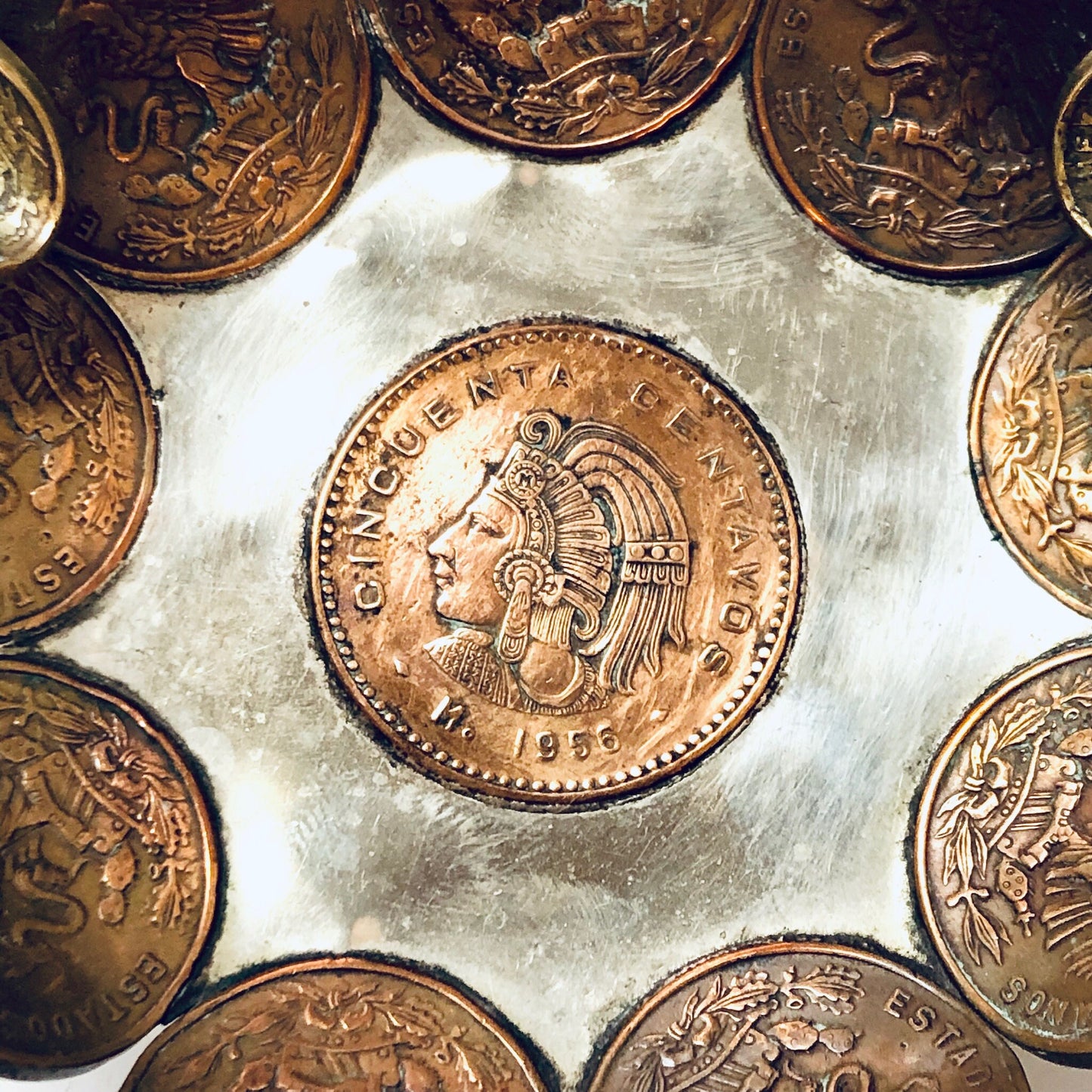 Vintage Mexican coin ashtray made of copper centavos, used as a catch-all dish, ring tray or decorative display for foreign currency coins.