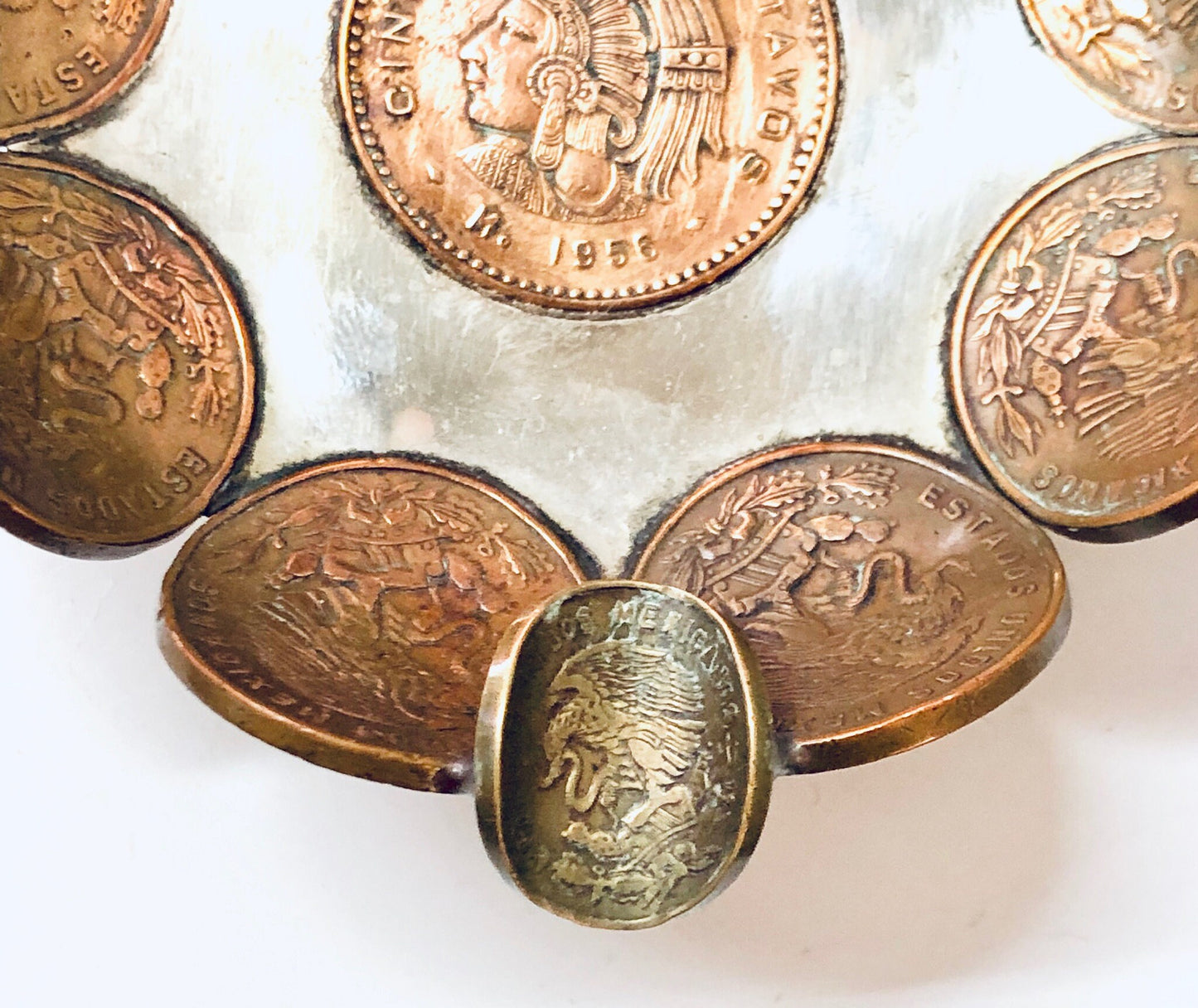 Vintage Mexican coin ashtray made of copper centavos, repurposed as a catch-all dish, ring tray or decorative display for foreign currency coins.