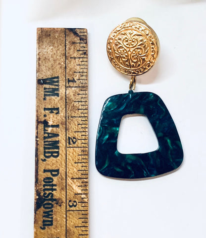 Vintage green and gold dangle earrings with marble design and pierced post backs, measuring against wooden ruler.