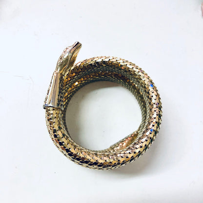 Vintage gold-toned Whiting and Davis mesh snake bracelet coiled in a spiral design, antique snake jewelry.