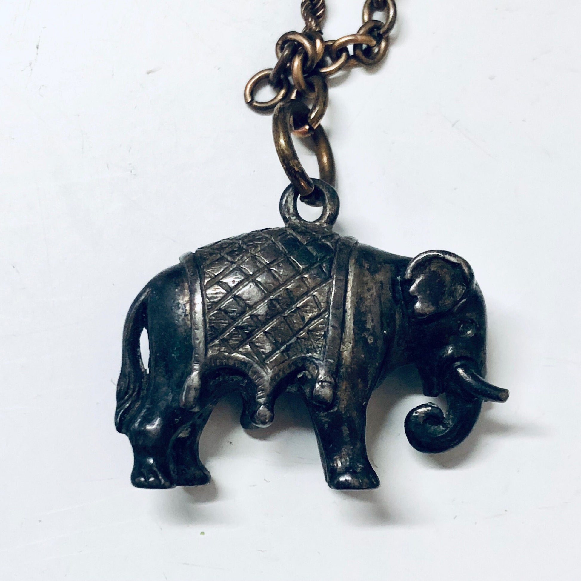 Vintage sterling silver elephant watch fob on chain with engraved design and ball charm.