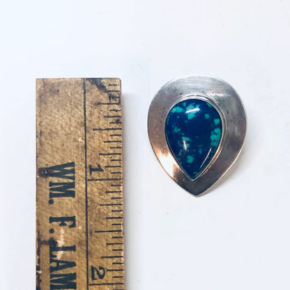 Vintage silver clip-on earrings featuring teardrop-shaped azurite malachite stones in shades of deep blue and green, placed next to an antique ruler for scale.