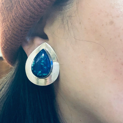 Blue azurite malachite teardrop earring on a woman's ear with brown hair