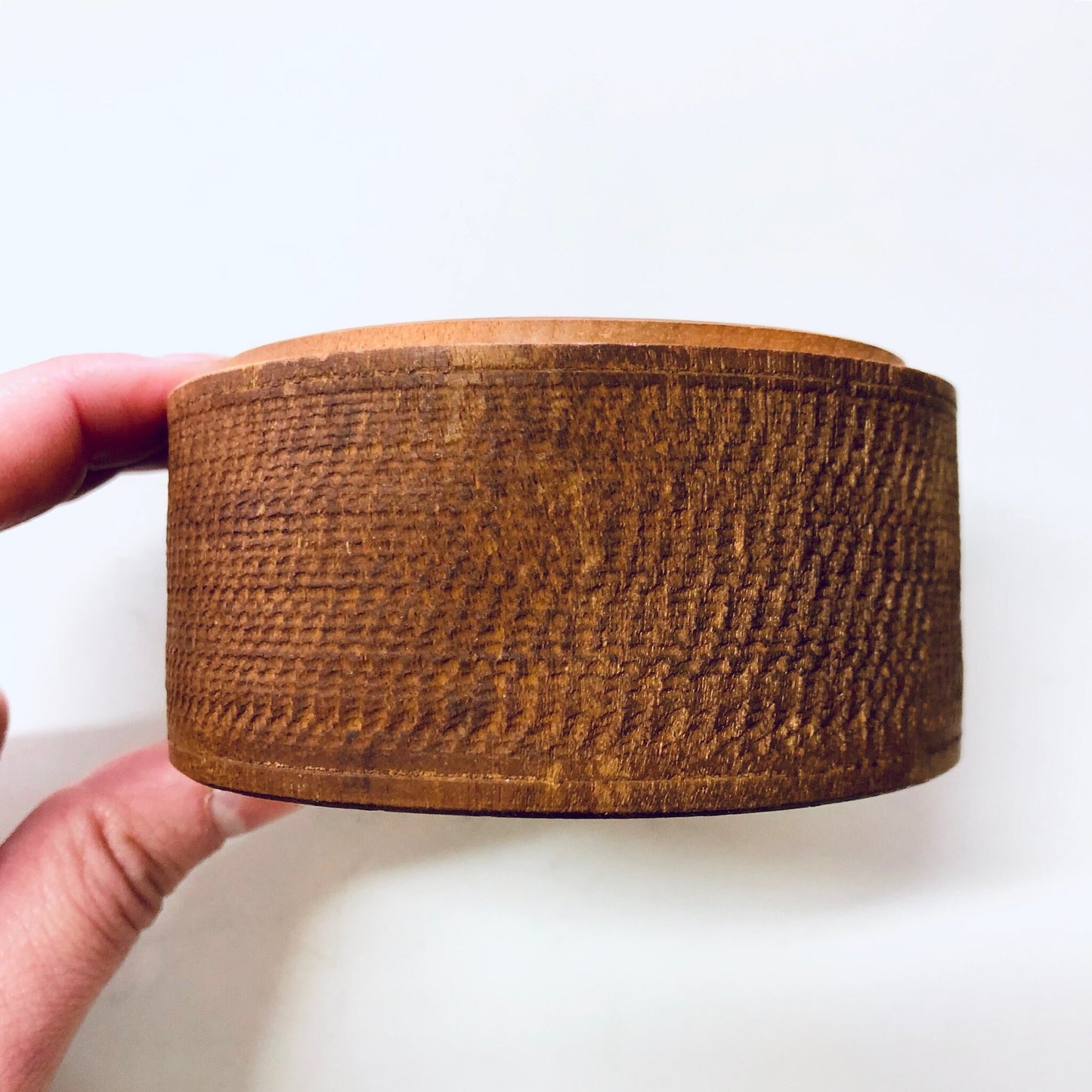 Handcrafted vintage wooden trinket box with intricate carved texture, perfect for storing small items or as unique home decor