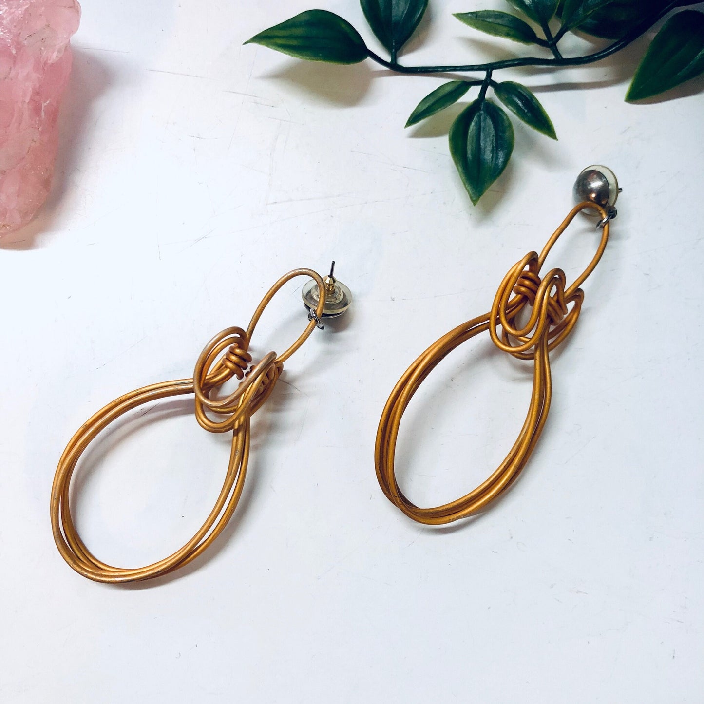 Vintage wire dangle earrings in orange and gold tones, abstract unique statement jewelry perfect for Valentines Day gift, shown with pink crystal and green leaves.