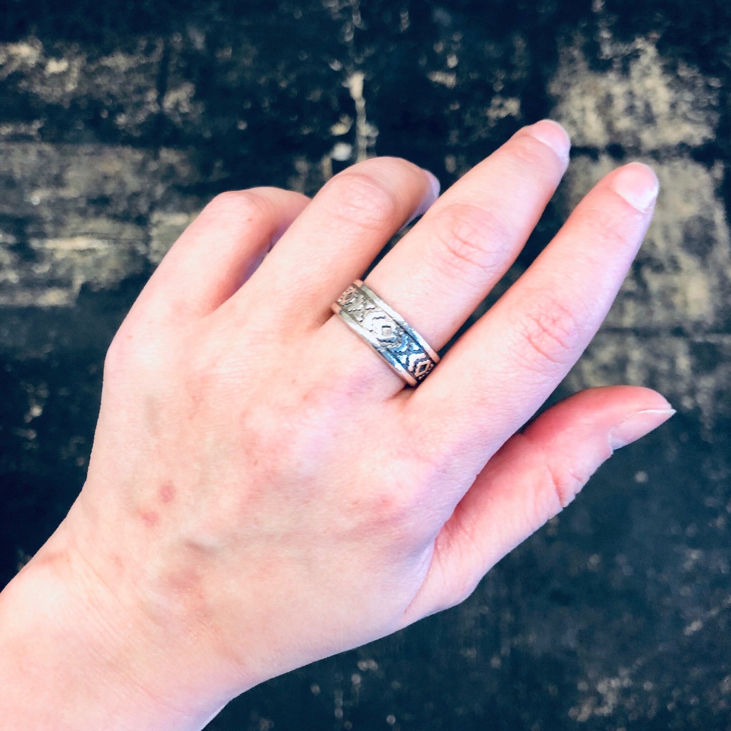 Vintage silver band ring with unique design worn on hand, bohemian style jewelry perfect as a gift for mom.