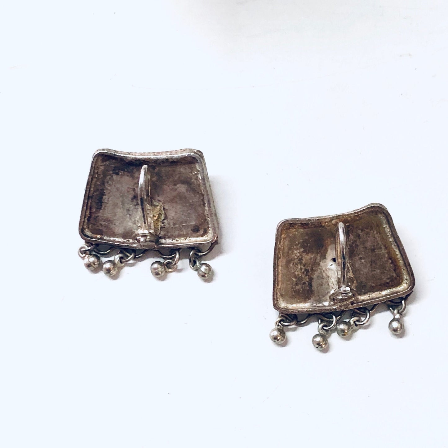 Vintage silver-toned dangle earrings with square shape and dangling ball accents, suitable for pierced ears and boho or wedding jewelry styles.