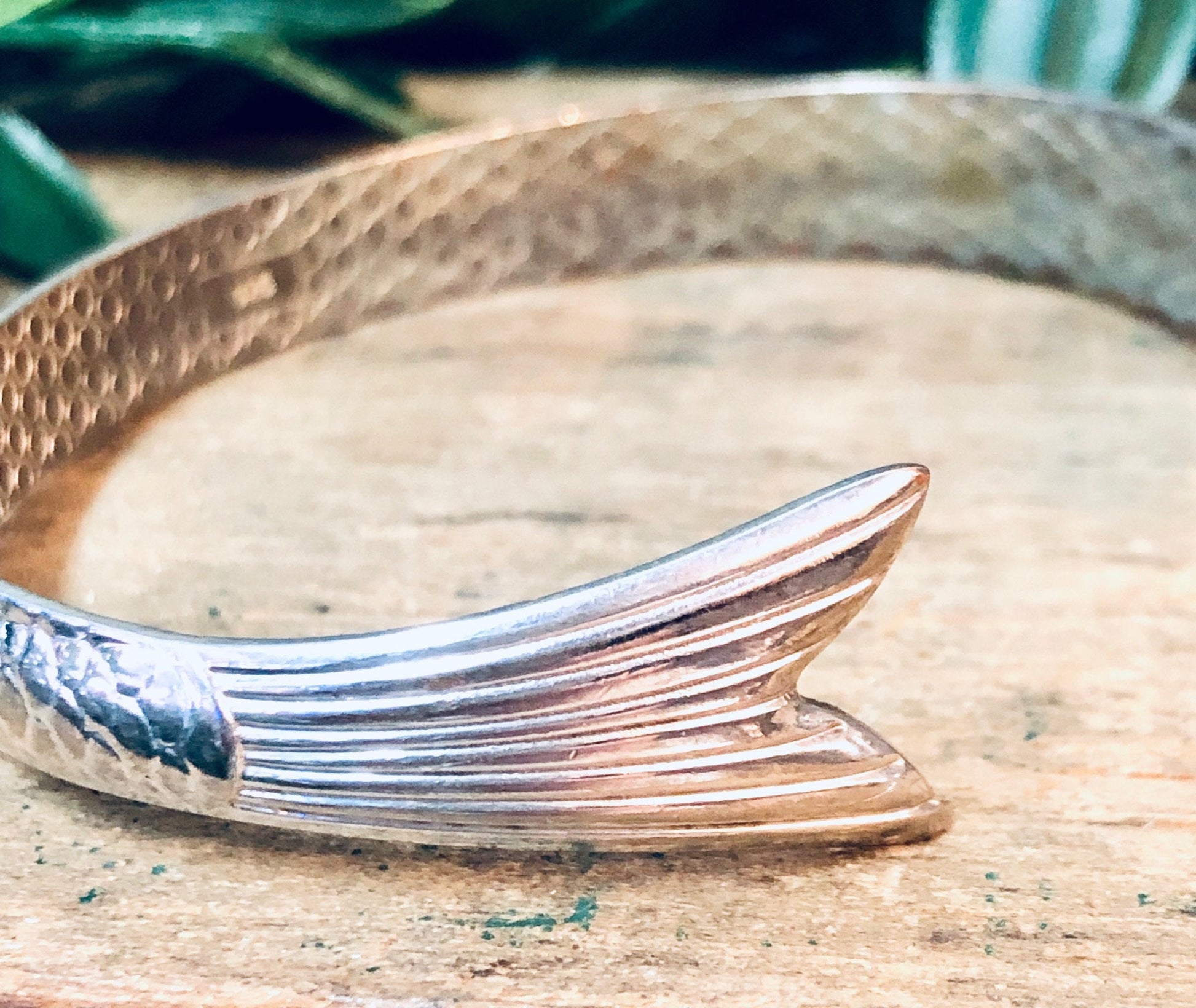 Silver fish bracelet on wooden surface, vintage aquatic animal bangle cuff jewelry