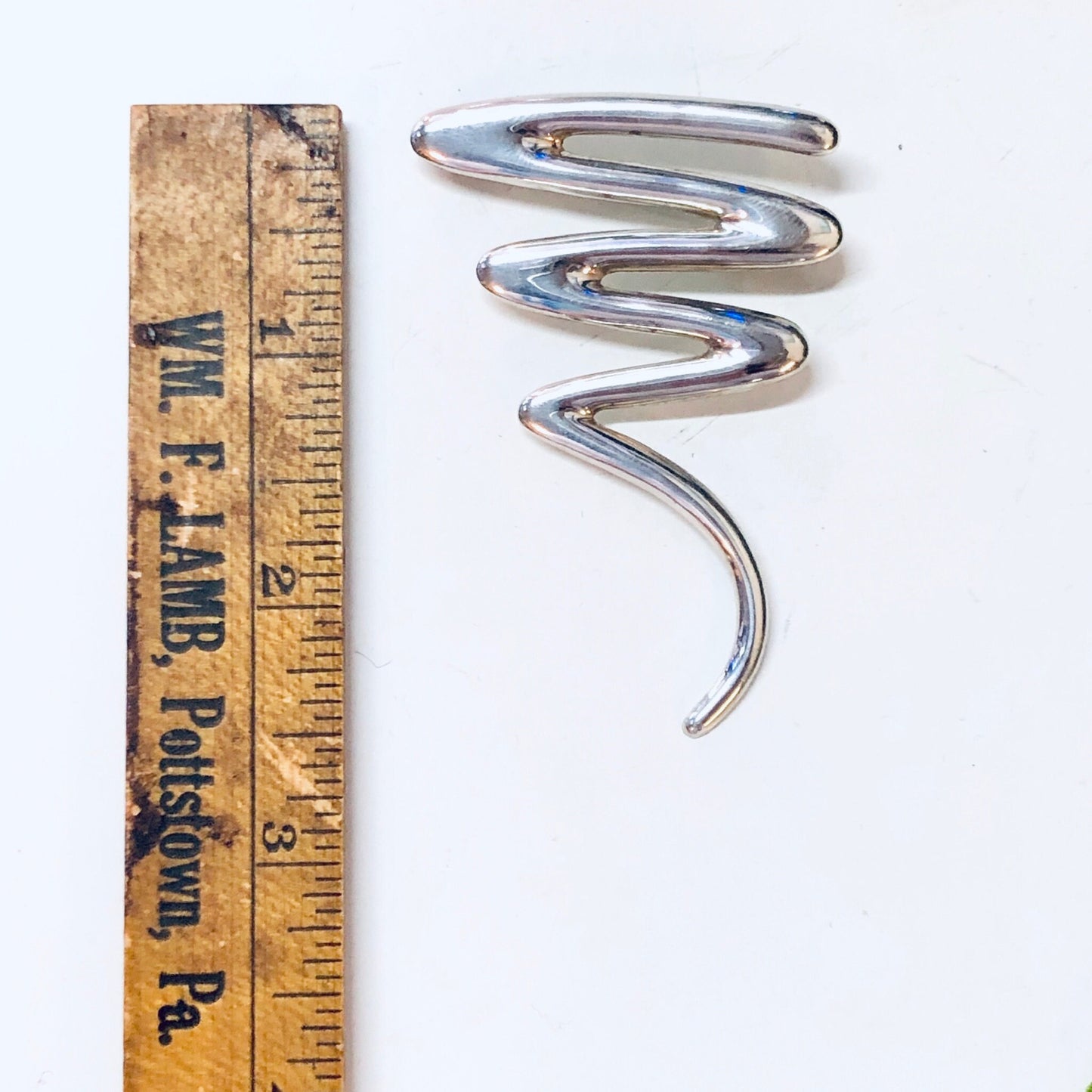 Vintage sterling silver abstract squiggle brooch pin jewelry, line design, on antique ruler for size reference, perfect Valentines Day gift.