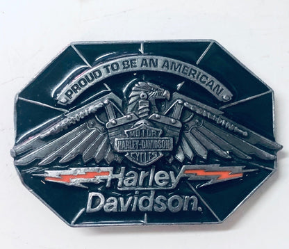 Vintage Harley Davidson belt buckle featuring an eagle with outstretched wings and the Harley Davidson logo, made of silver-colored metal with red accents, a collectible biker accessory.