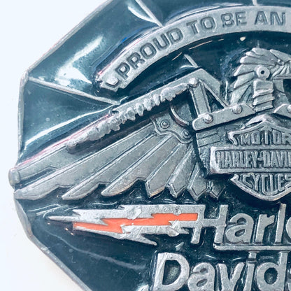 Vintage Harley Davidson belt buckle featuring an eagle design and "Proud to be an American" text, collectible biker accessory and gear.